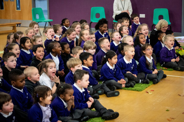 Delighted children watch the performance of Four Go Wild in Wellies