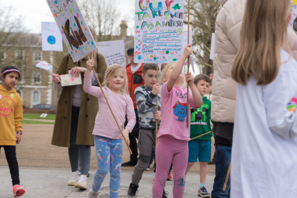 Children march with creative protest banners